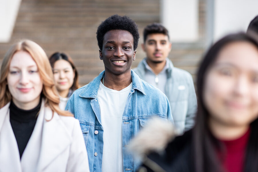 Multiracial crowd of people in the city commuting and walking on